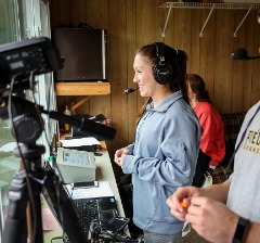 Percival on the mic for Piedmont softball during the 2018 season.